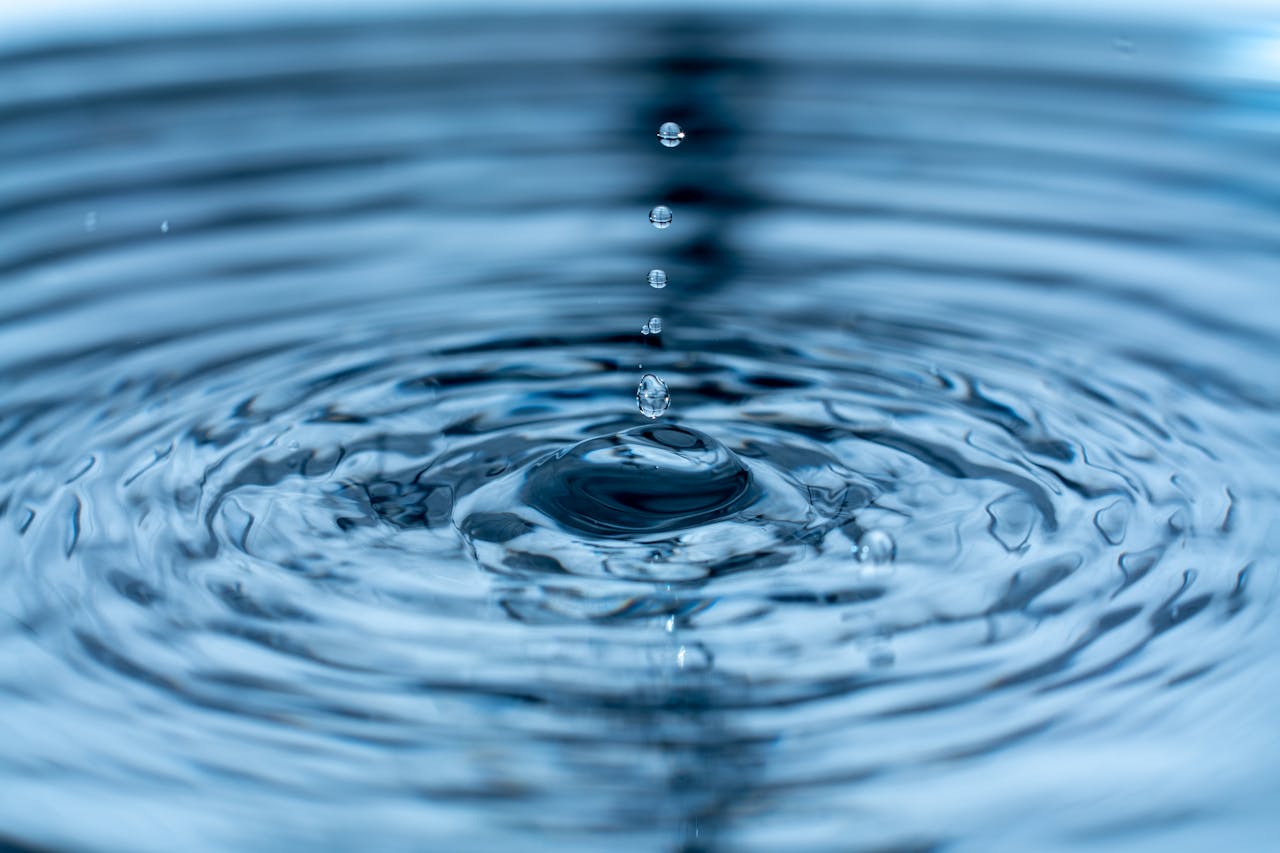 A mesmerizing close-up of water droplets and ripples, capturing dynamic motion and beauty.
